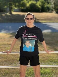 A woman wearing black shorts and a t-shirt.