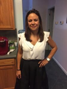 A woman standing in front of a kitchen counter.