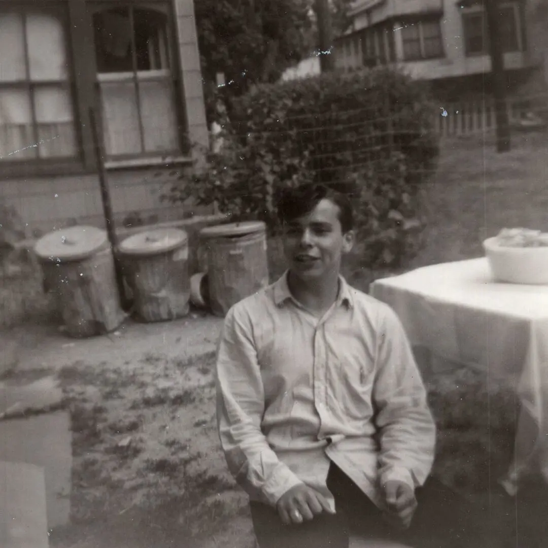A man sitting in front of an outdoor table.