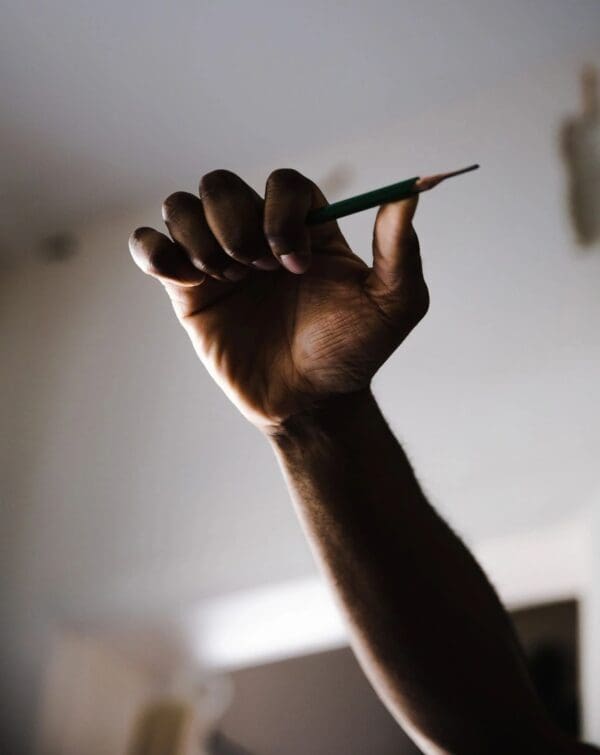 A person holding a pen in their hand.